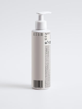 Gentle Cleansing Milk bottle with a pump dispenser for nourishing and makeup-removing facial cleansing.