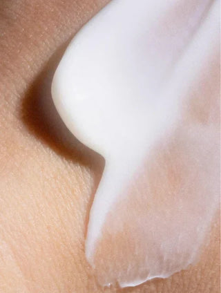 Close-up of Brightening Eye Cream texture on skin, showcasing its smooth, lightweight formula.